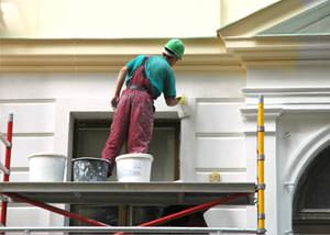 An exterior painter working on a home in Madera